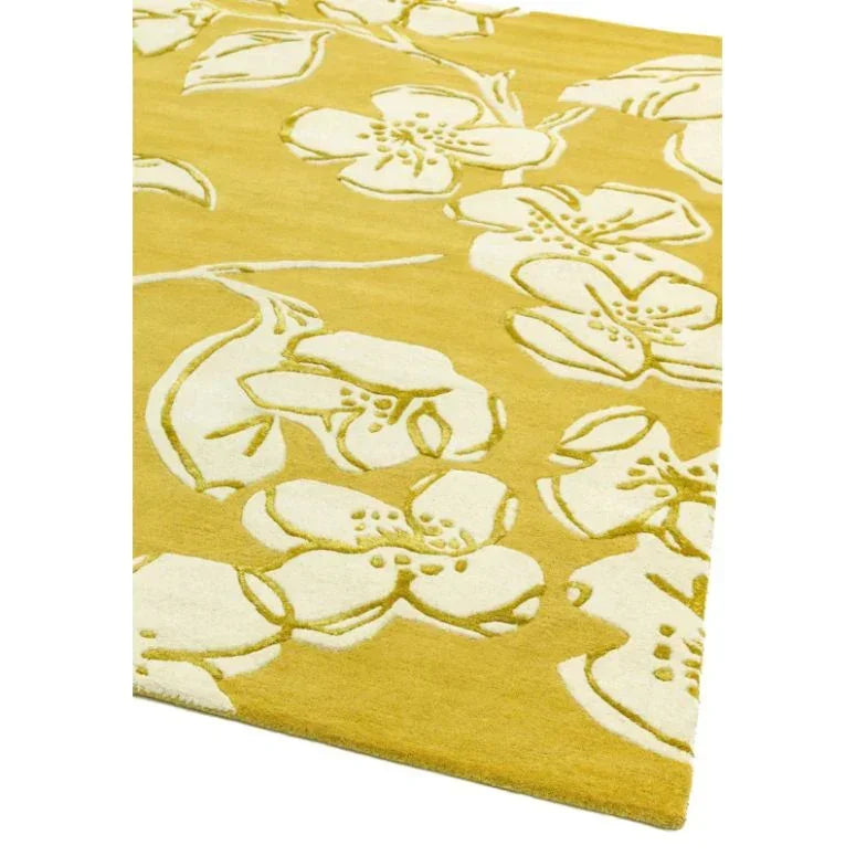 Yellow floral area rug with white flower pattern and soft textured surface