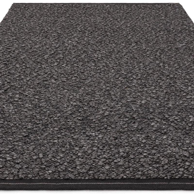 Charcoal loop pile doormat with textured surface shown from angle
