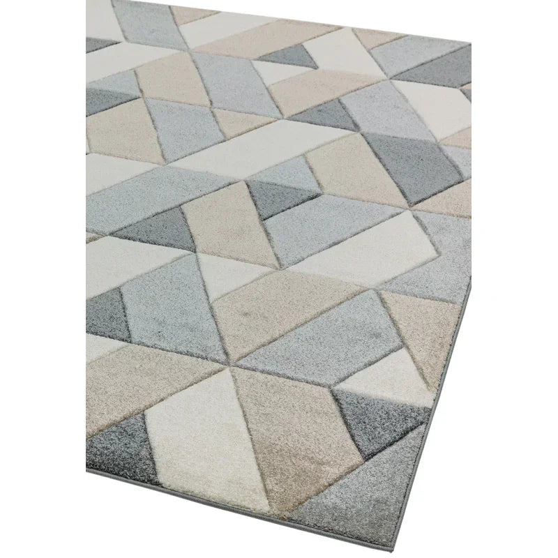 Geometric patterned rug in grey, beige and cream tones, shown from corner angle