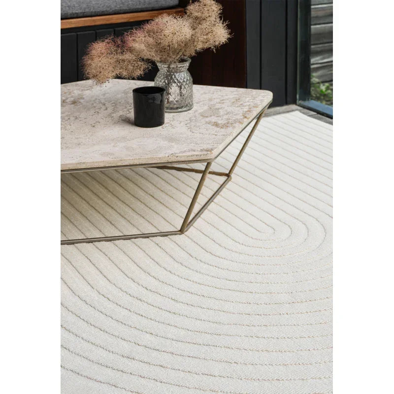 Cream textured area rug under geometric coffee table in modern living room