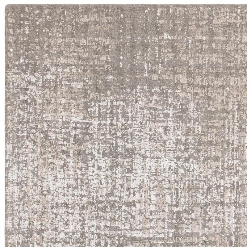 Textured beige area rug with abstract pattern and soft pile, close-up of corner