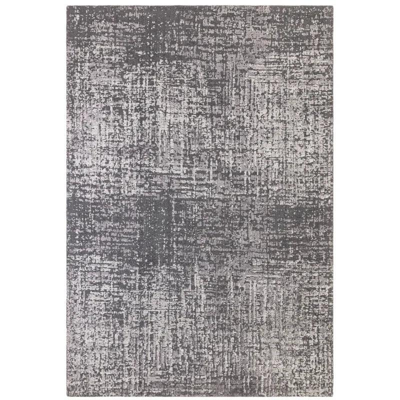 Grey abstract patterned rug with textured surface and modern design