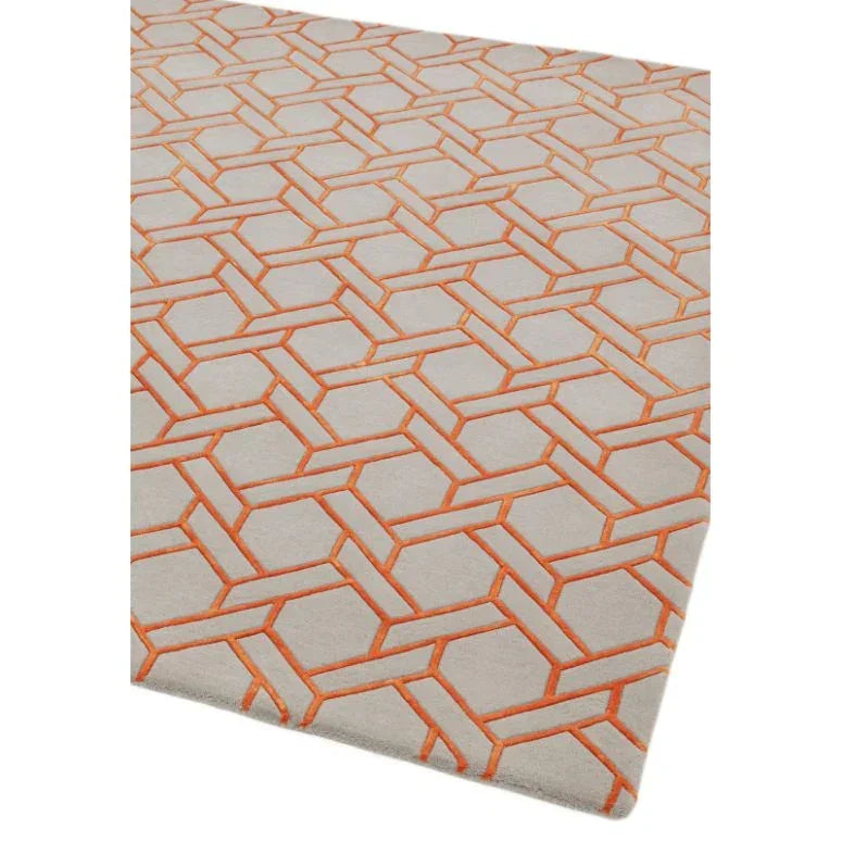 Geometric orange and beige area rug with textured pattern, angled corner view