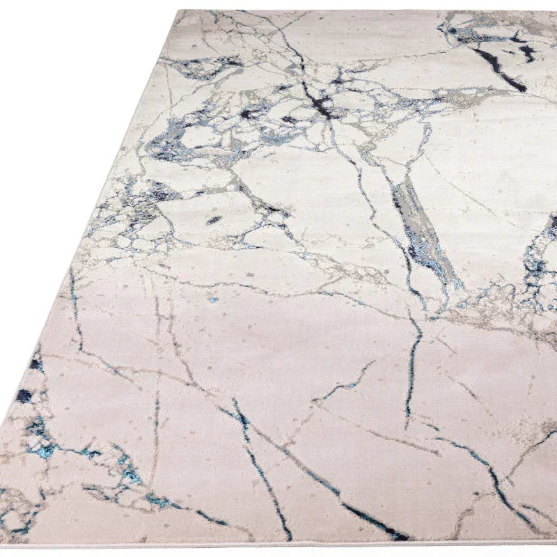 Modern area rug with marble effect pattern in shades of white, grey and blue