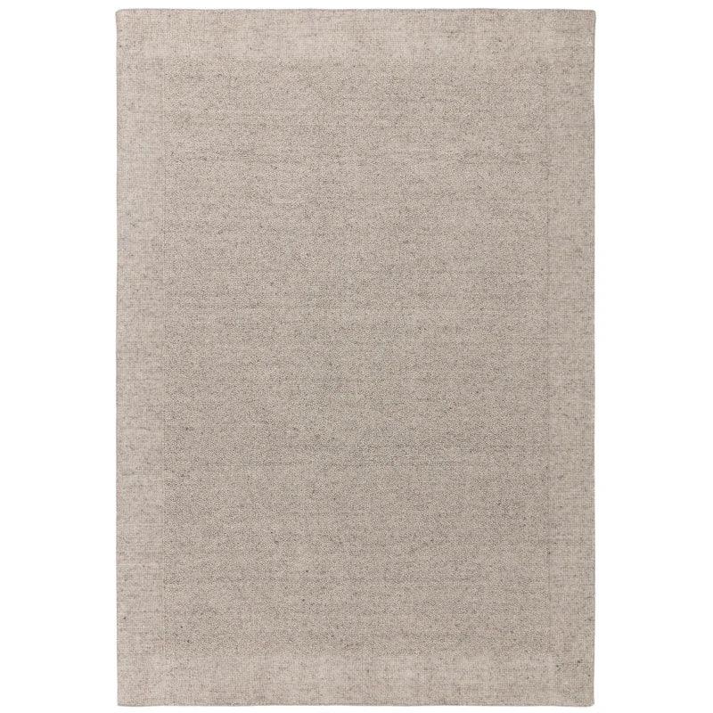 Large rectangular beige area rug with subtle texture, shown from above