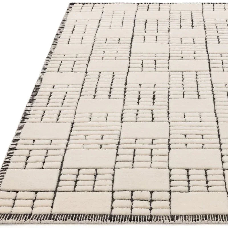 Cream geometric rug with raised textured grid pattern and dark border detail