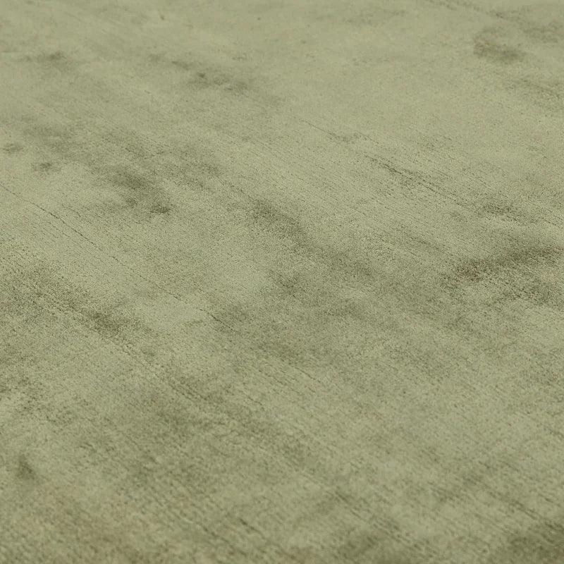 Light green area rug with soft textured surface and subtle pattern, shown in close-up view