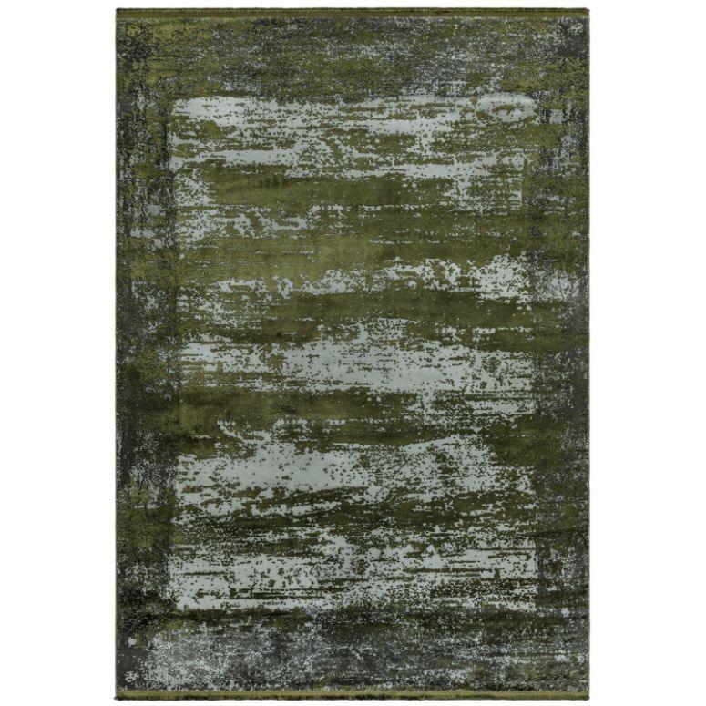 Green abstract area rug with textured pattern and distressed finish