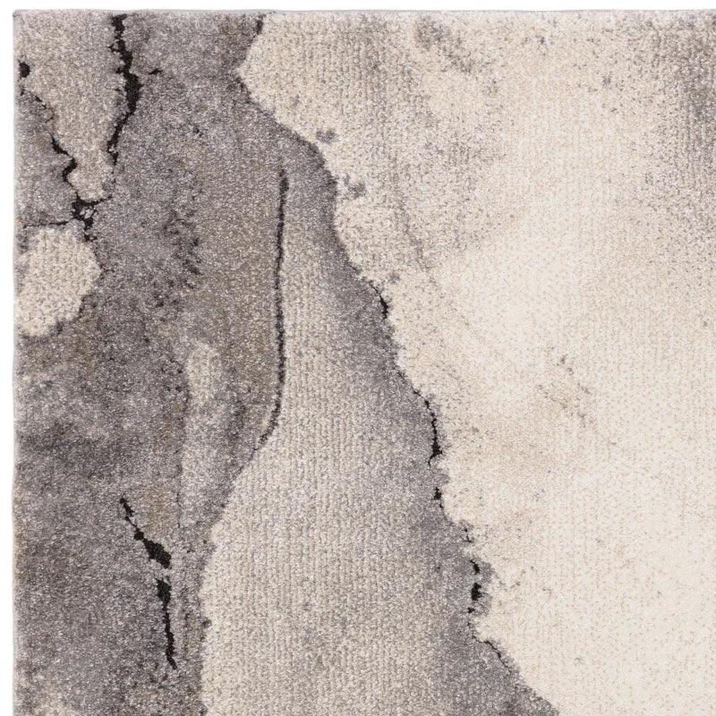 Grey and cream abstract patterned rug with textured surface