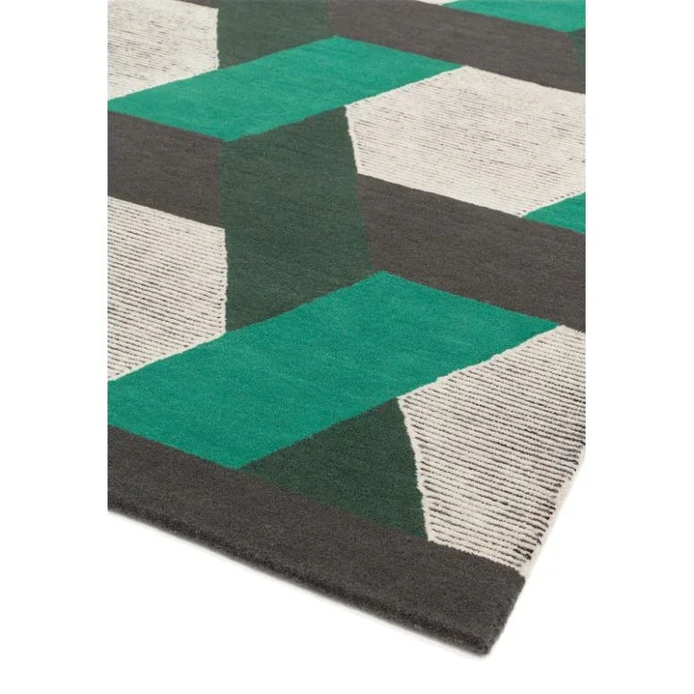 Geometric patterned rug with green, grey, and white blocks, close-up corner view