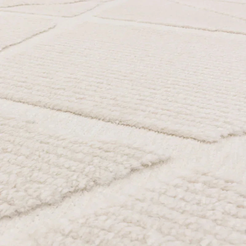 Close-up of textured cream rug with raised rectangular patterns