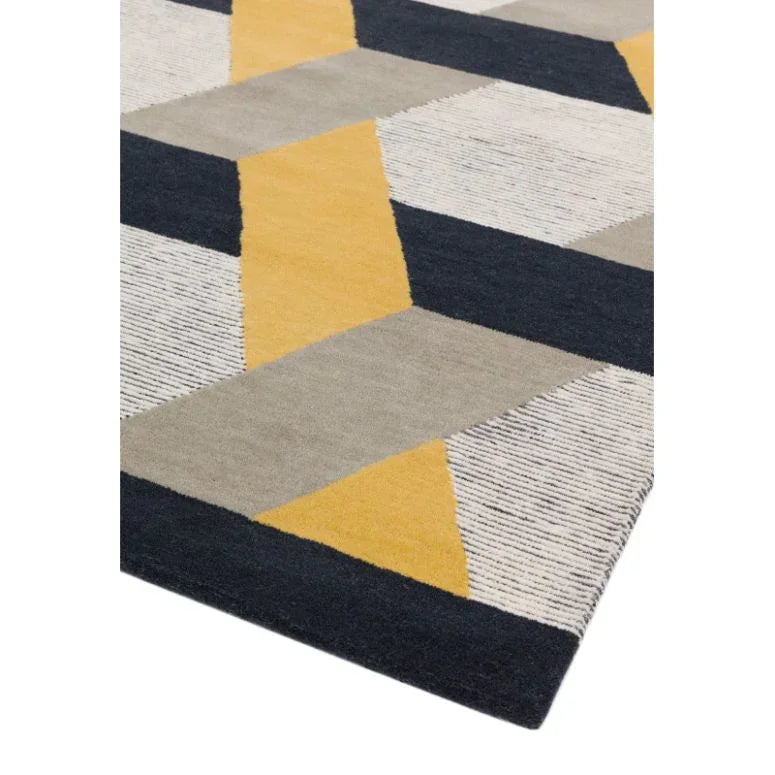 Geometric patterned rug with yellow, grey, and black blocks viewed from corner angle