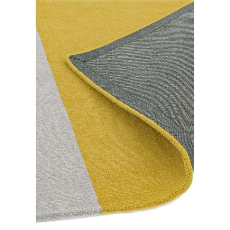Yellow and grey area rug with visible corner fold and textured fabric detail