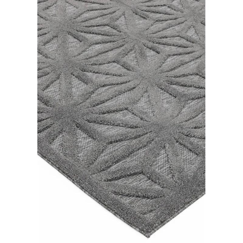 Grey geometric patterned rug with textured surface and angular design