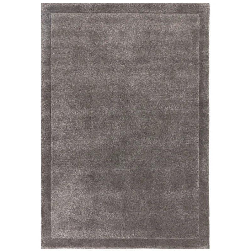 Grey rectangular area rug with subtle border design, soft texture, suitable for living room
