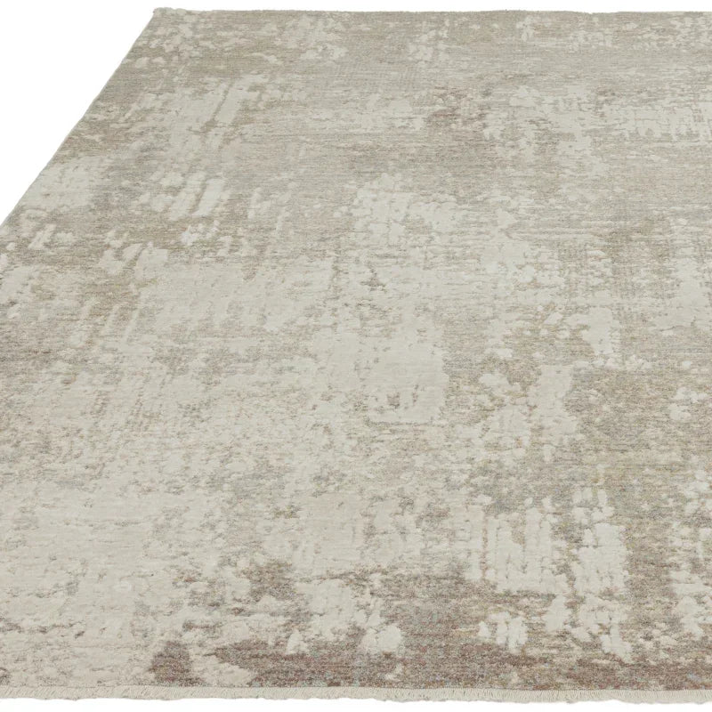 Neutral textured area rug with abstract beige and grey pattern, close-up view