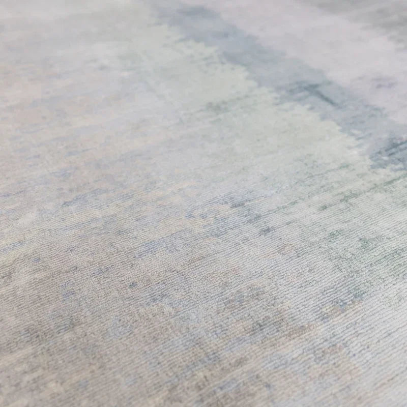 Close-up of neutral color area rug with subtle gradient and soft texture