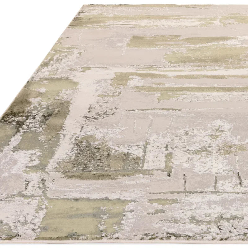 Beige abstract rug with textured design and green accents, corner angle view