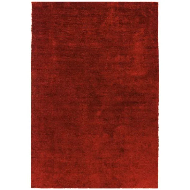 Red area rug with solid color and plush texture, rectangular shape, top-down view