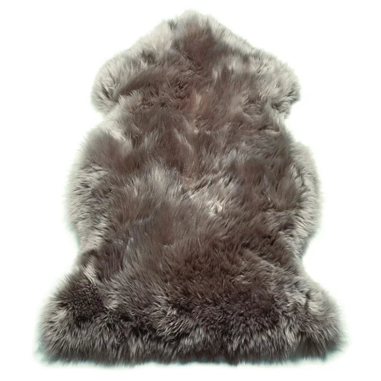 Grey sheepskin rug with long pile and natural shape on white background