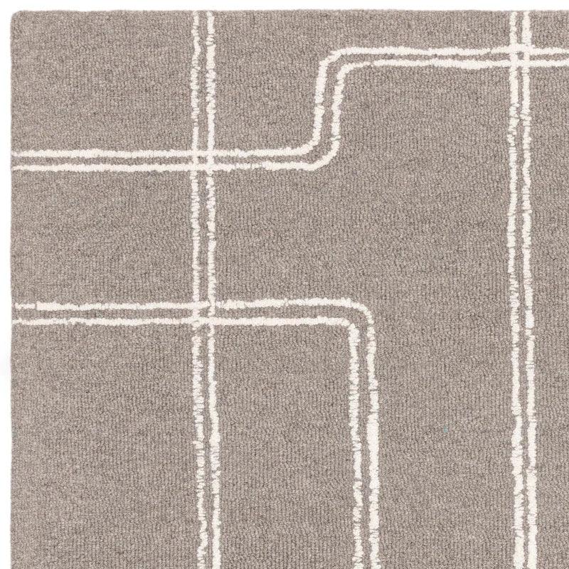Grey rug with white geometric linear pattern, close-up of textured surface