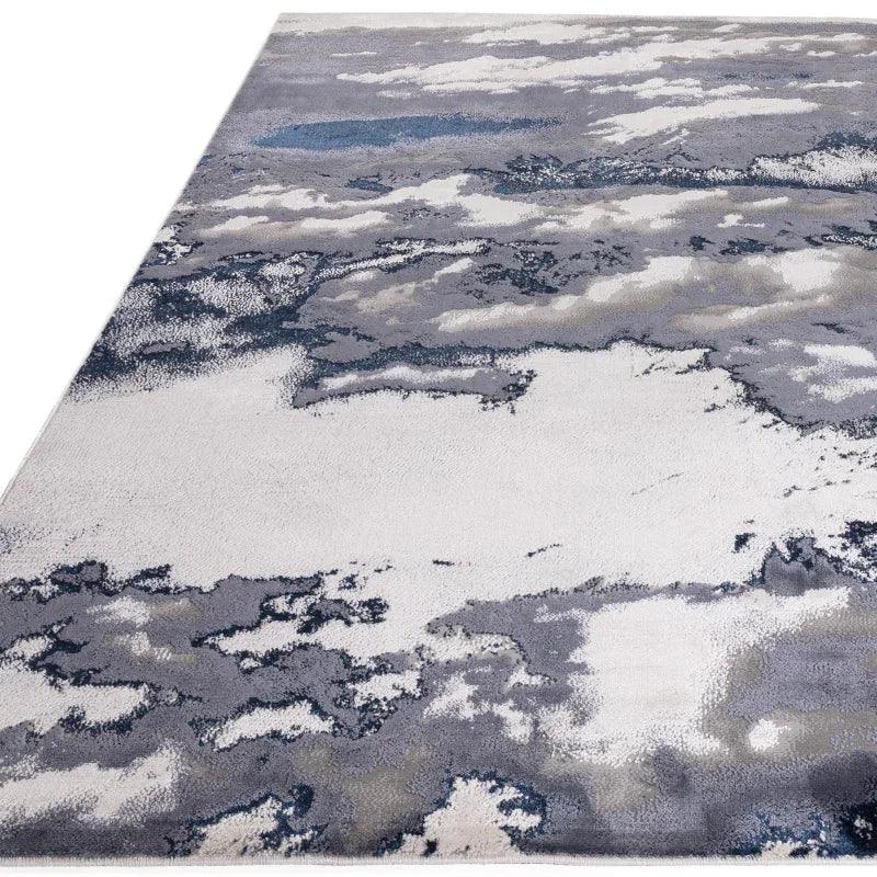 grey and white abstract area rug with textured pattern