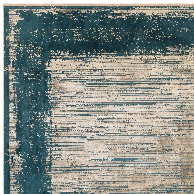 Teal and cream area rug with distressed border and linear textured pattern