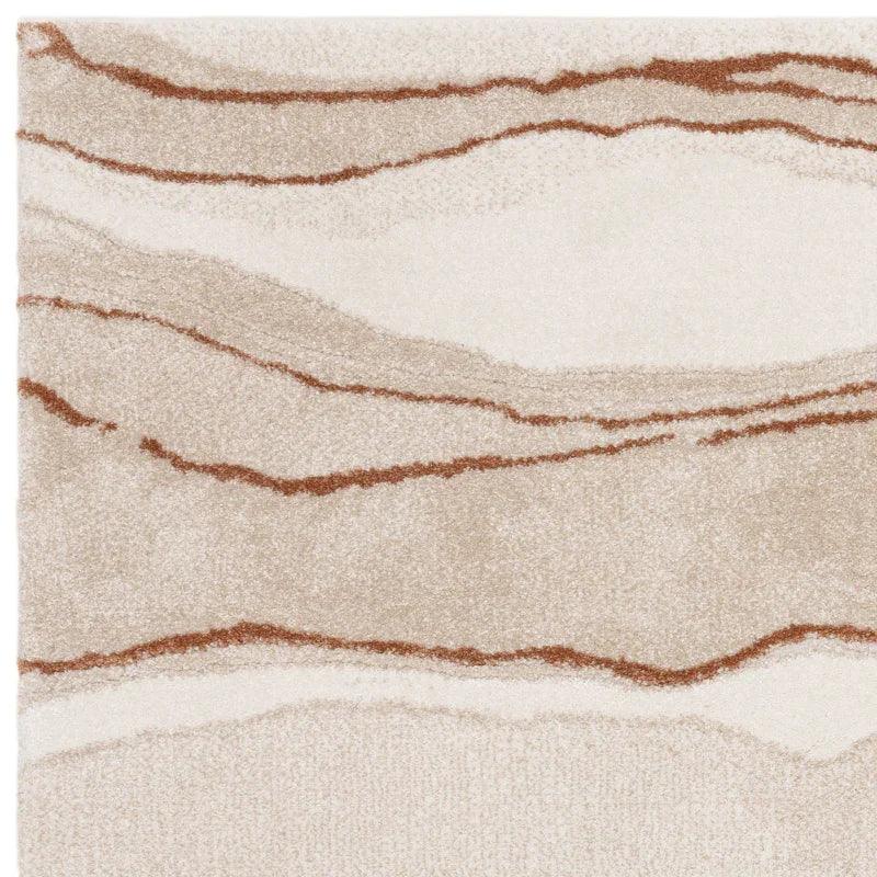 Beige and brown abstract area rug with wavy lines and soft textured pile