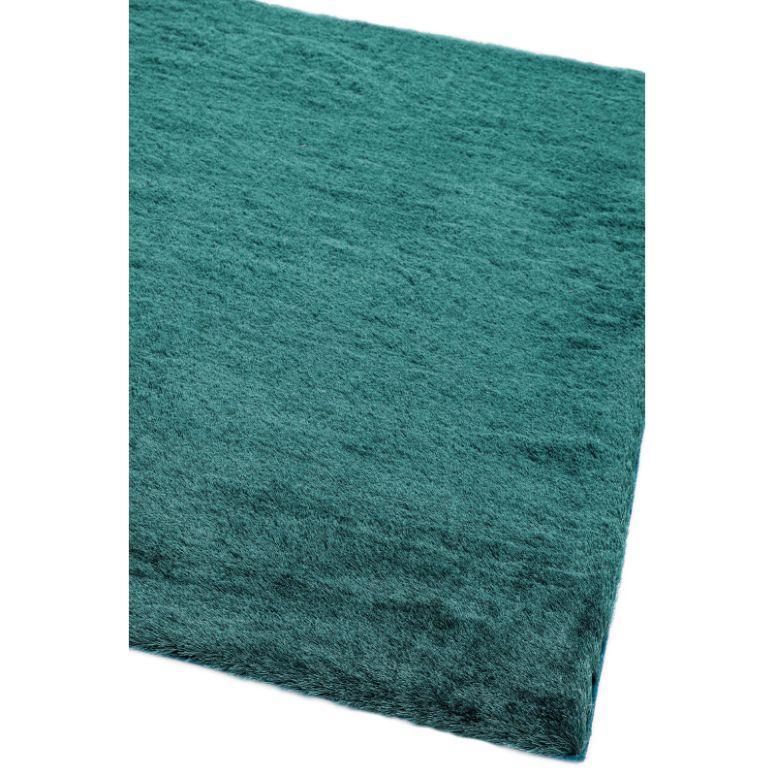 Teal area rug with soft textured surface corner view