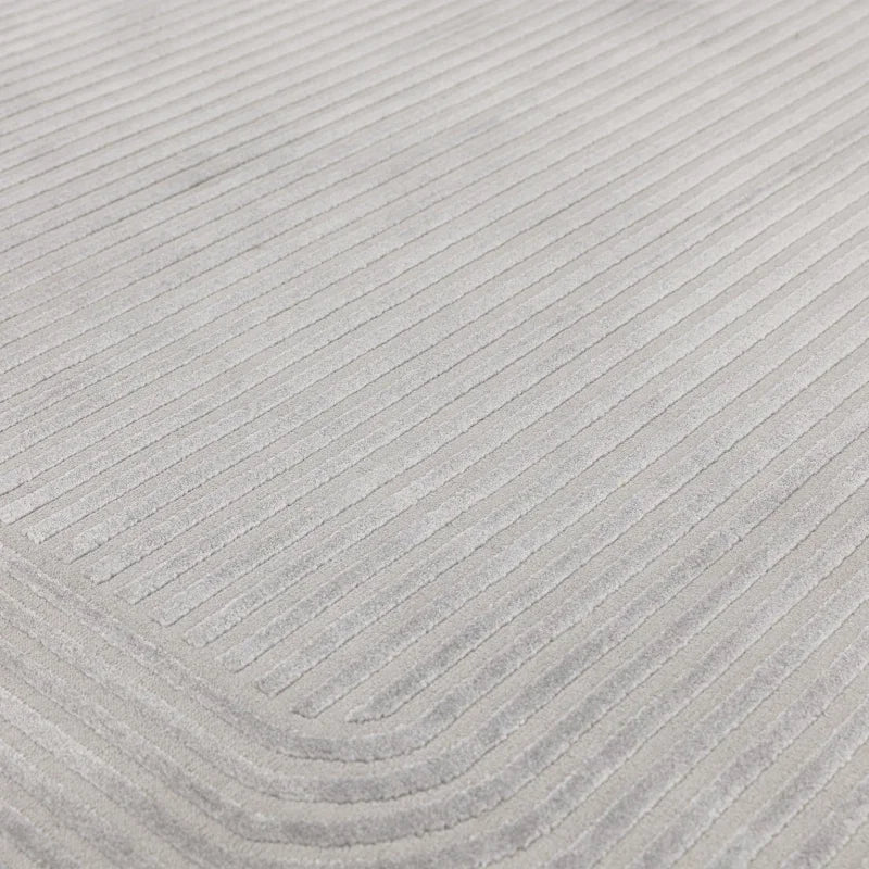 Light grey corduroy fabric upholstery with vertical and curved stitched lines