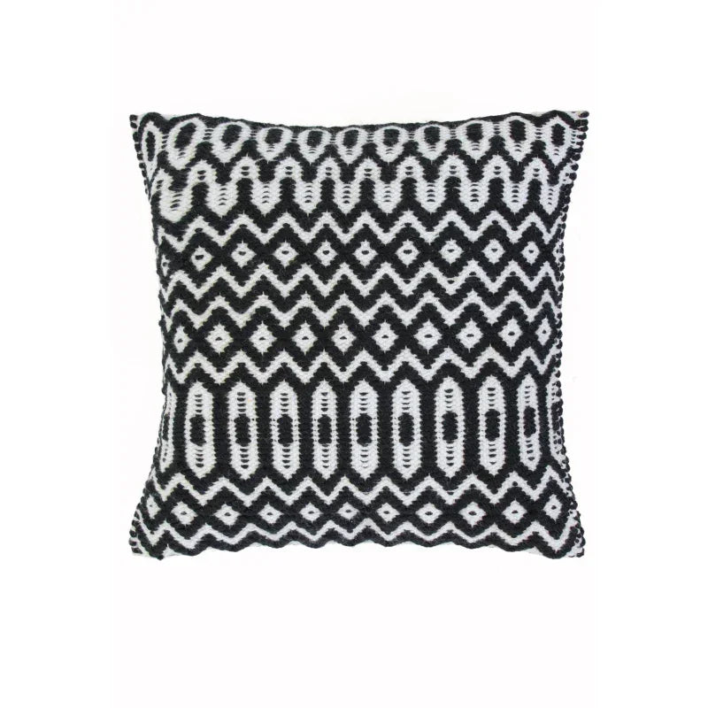 Black and white patterned cushion with geometric zigzag and oval design