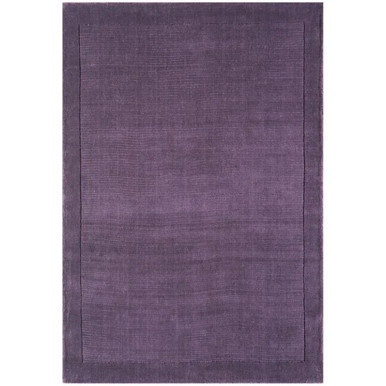 Purple area rug with subtle border and textured finish