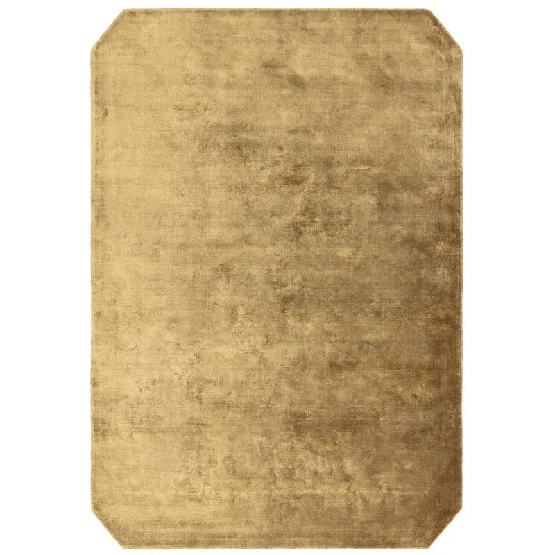 Beige rectangular rug with cut corners and soft textured surface
