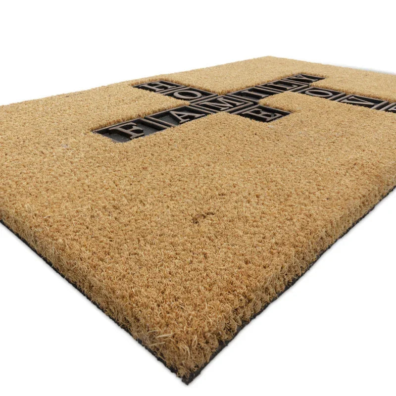 Coir doormat with carved black cross pattern and textured surface, close side angle view