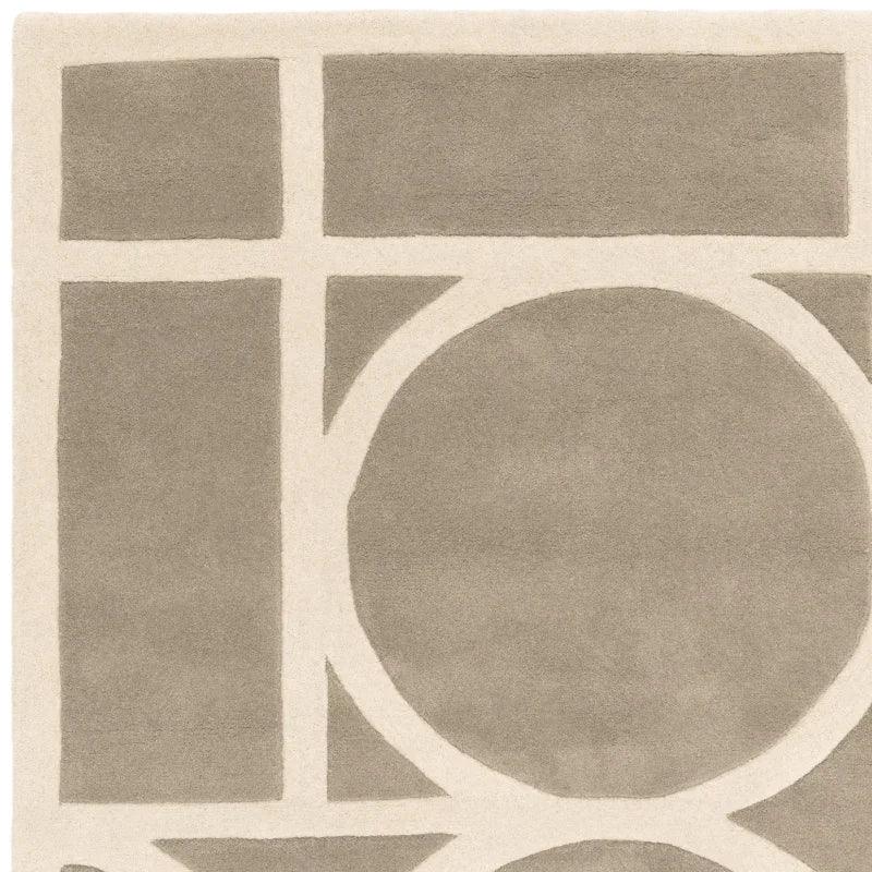 Grey and cream modern rug with geometric circle and line patterns, close-up view