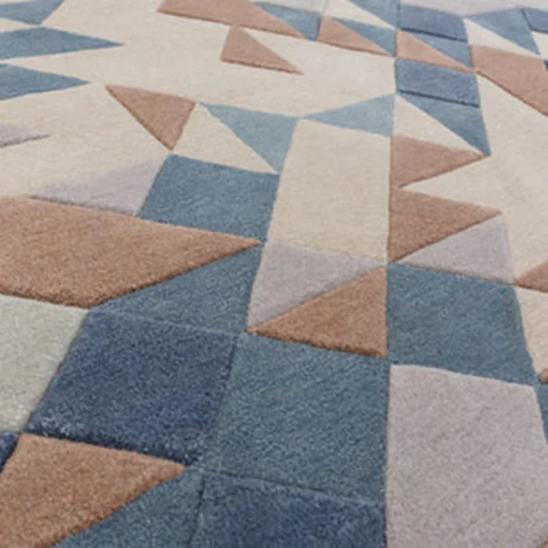 Geometric patterned rug with blue, cream and brown triangles and squares