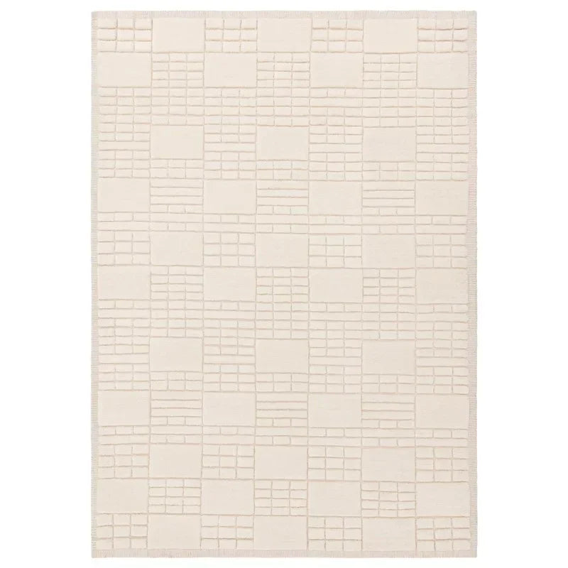 Cream geometric patterned area rug with raised textured squares and rectangles
