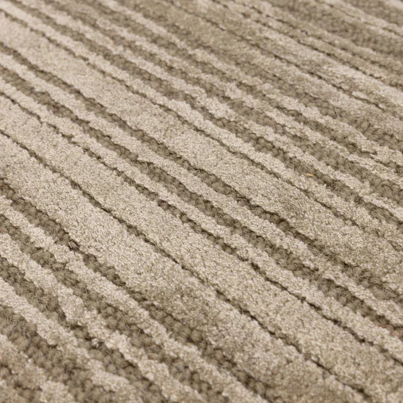 Beige textured rug with subtle linear pattern and raised woven detail