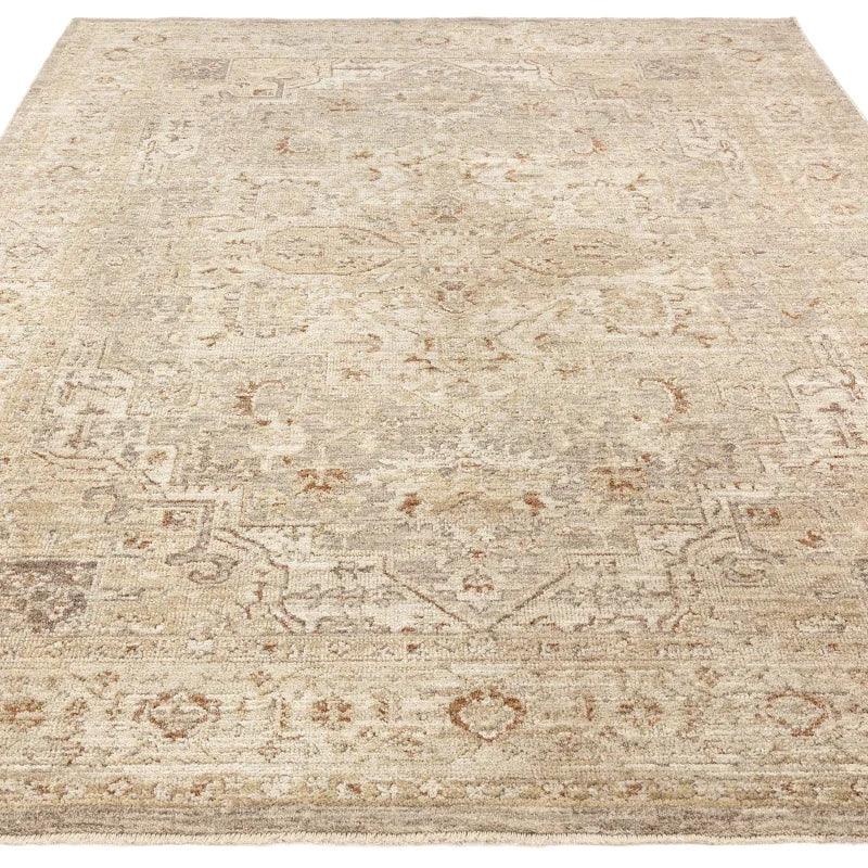 Neutral vintage area rug with subtle traditional pattern and distressed finish