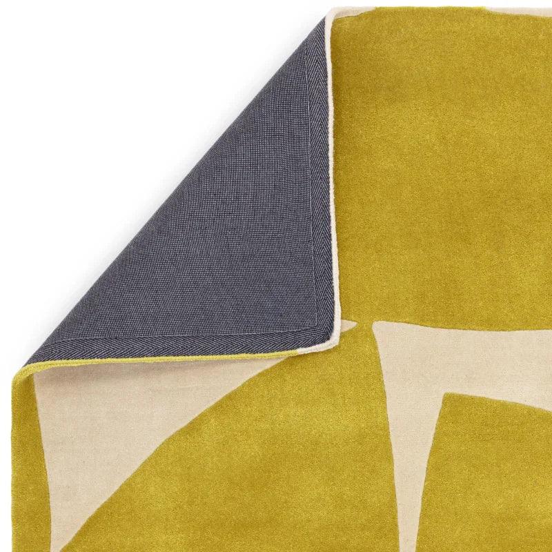 Yellow geometric pattern rug corner folded to show grey backing