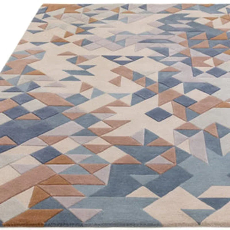 Geometric patterned area rug with blue, beige and brown triangles, angled view