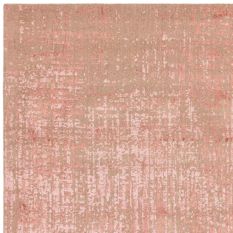 Rectangular blush pink abstract rug with textured pattern and soft beige background