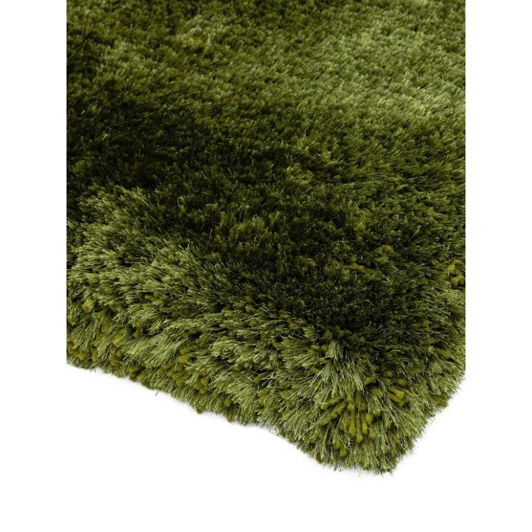 Close view of green shaggy rug corner showing thick pile texture