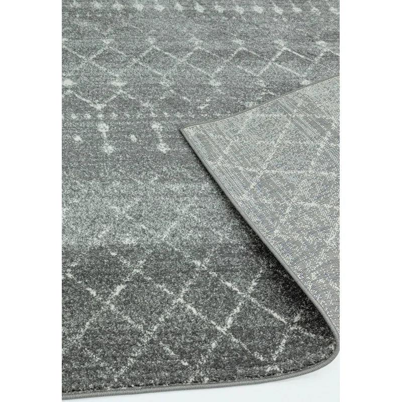 Grey patterned area rug with diamond design and detailed view of corner and edging