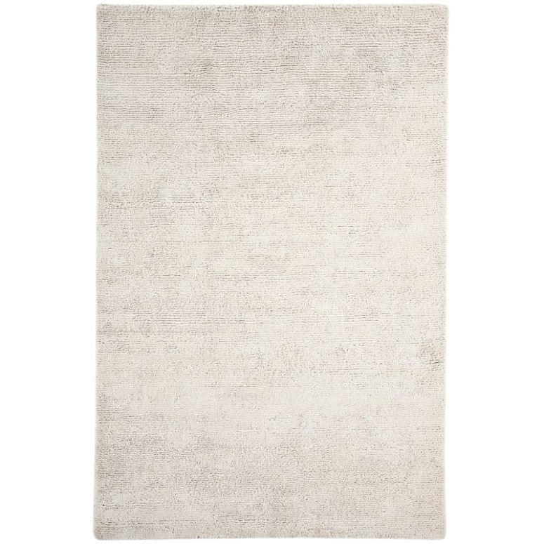 Large rectangular cream area rug with soft texture and subtle pattern