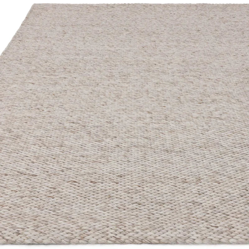 Neutral woven wool rug with textured surface in close-up angle