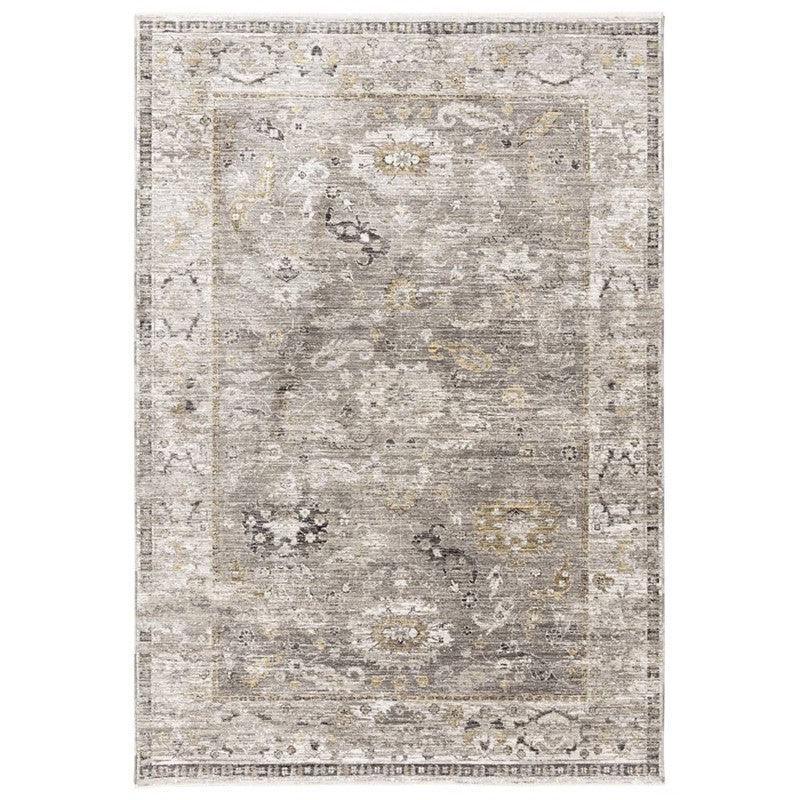 Grey patterned area rug with subtle floral and geometric border design