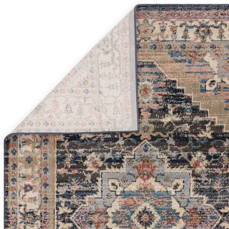 Traditional patterned area rug with multicolour design, one corner flipped to show backing