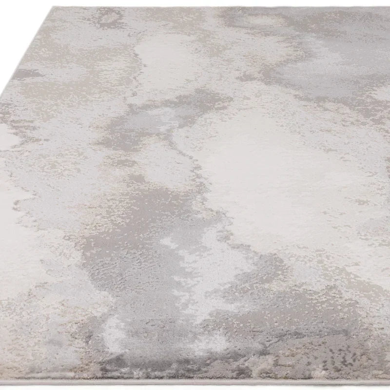 Modern area rug with abstract grey and cream pattern, close view of textured surface