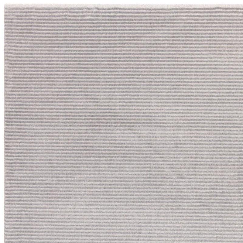 Light grey textured rug surface with horizontal ribbed pattern close-up